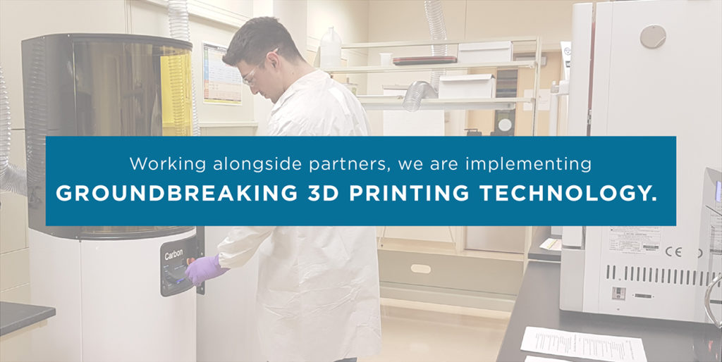 A MediSurge employee works in the Class 7 Cleanroom while font over him reads, "Working alongside partners, we are implementing groundbreaking 3D printing technology."